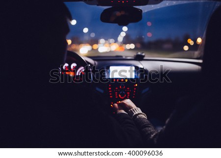 A couple holding hands in the car on the way home. Back view. Night city Royalty-Free Stock Photo #400096036