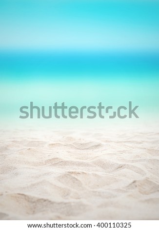 Close up sand with blurred sea sky background, summer day, copy space or for product.