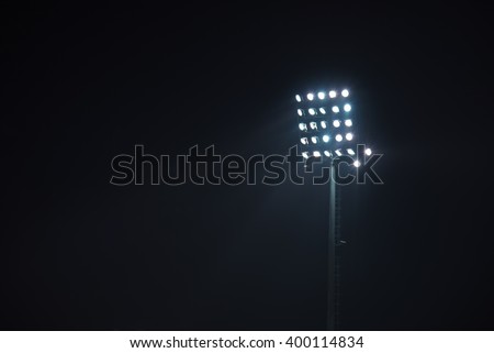 Stadium lights against dark night sky background Royalty-Free Stock Photo #400114834