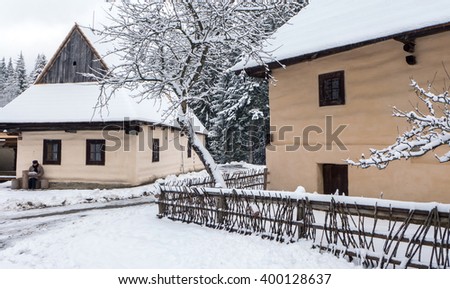 Open-air musem at village Zuberec, Slovakia. Snowy village -r ural cottage. Royalty-Free Stock Photo #400128637