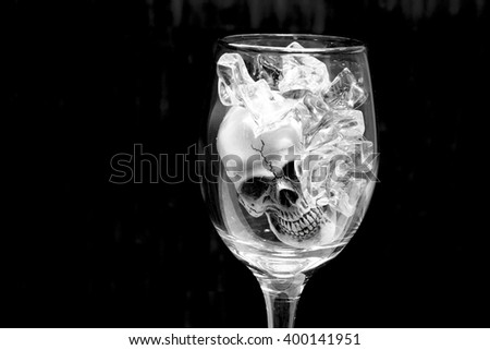 Still life with Skull in a glass of wine with ice.