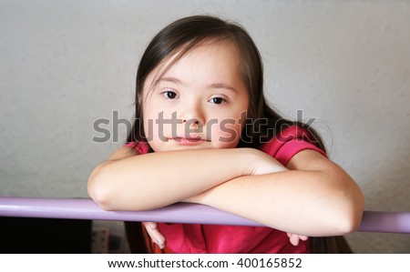 Portrait of little girl on the backgroung of the grey wall