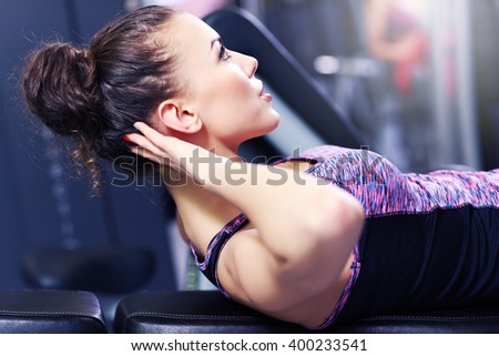 Picture of fit woman doing sit ups in gym