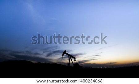 Sunset in the oil field - Silhouette of crude oil pump - Bahrain
