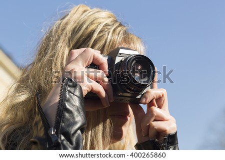 Photographer woman with camera outdoors