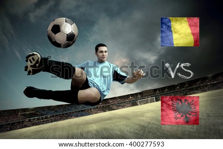 Football player on soccer field of stadium. Match between two national teams.
