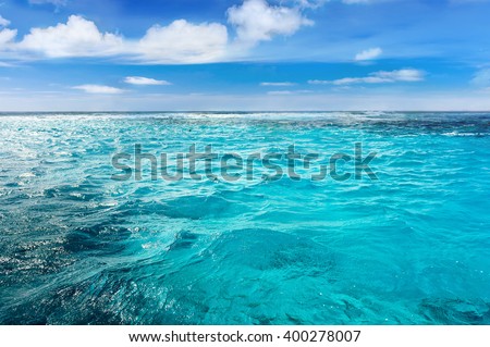 Caribbean sea surface summer wave background. Exotic water landscape with clouds on horizon. Natural tropical water paradise. Cuba nature relax. Travel tropical island resort. Ocean nature tranquility Royalty-Free Stock Photo #400278007