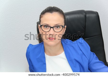 Photo of the Pretty Business woman analyzing investment charts with calculator and laptop