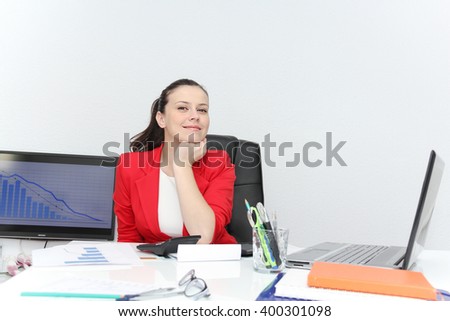 Photo of the Pretty Business woman analyzing investment charts with calculator and laptop