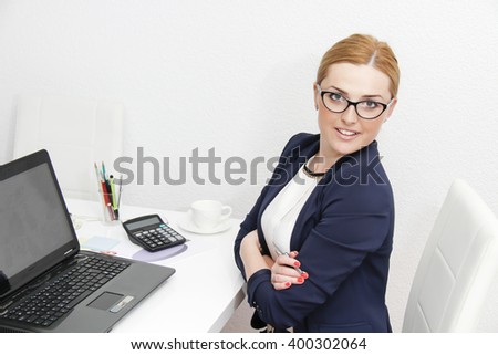 Photo of the Business woman analyzing investment charts with calculator and laptop
