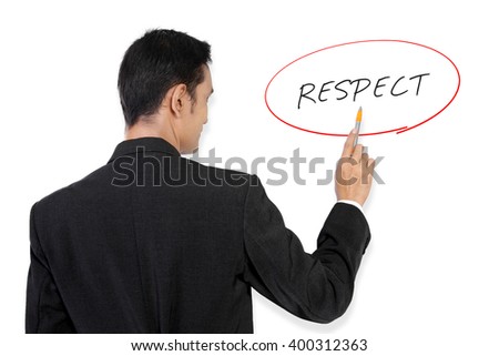 Businessman pointing at "Respect" handwritten text on white board with his pen Royalty-Free Stock Photo #400312363