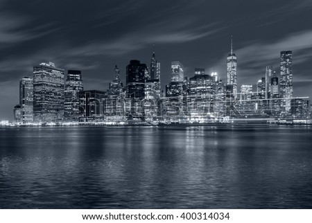 Panoramic view New York City Manhattan downtown skyline at night with skyscrapers and blue tonality