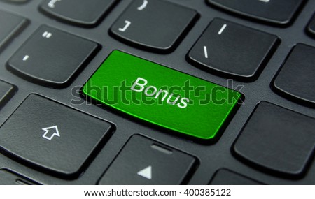 Business Concept: Close-up the Bonus button on the keyboard and have Lime, Green color button isolate black keyboard