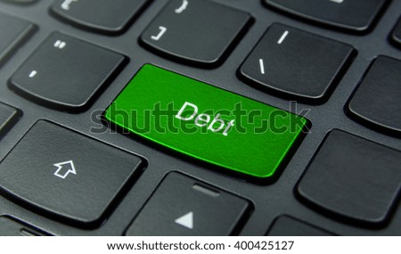 Business Concept: Close-up the Debt button on the keyboard and have Lime, Green color button isolate black keyboard