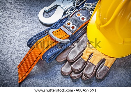 Construction safety harness protective gloves hard hat on black background maintenance concept. Royalty-Free Stock Photo #400459591