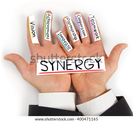 Photo of hands holding SYNERGY paper cards with concept words