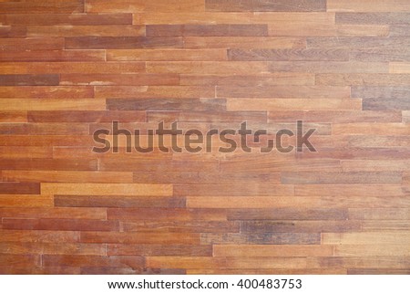 Brown wood background. Leaflets are arranged in a line.