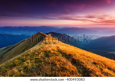 A great view of the hills glowing by sunlight at twilight. Dramatic and picturesque morning scene. Location place: Carpathian, Ukraine, Europe. Artistic picture. Beauty world. Warm toning effect.