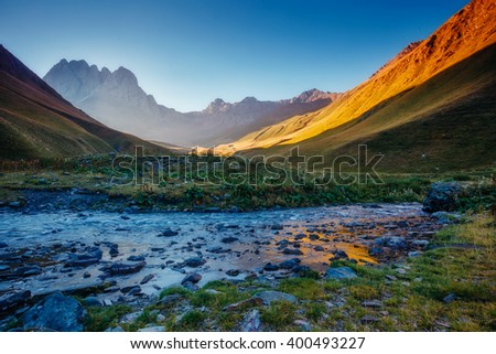 The picturesque view of the mountains that glow under sunlight. Location place: Juta village - foot of Mt Chaukhebi. Georgia, Europe. Caucasus range. Dramatic scene. Artistic picture. Beauty world.