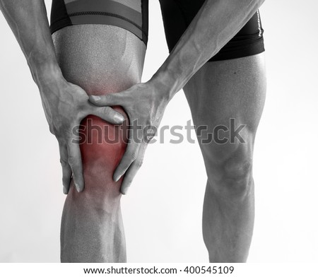 Young man with knee pain .  Royalty-Free Stock Photo #400545109