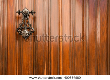 Authentic vanished Spanish door and black iron knocker. for use of  copy space, text and background.
