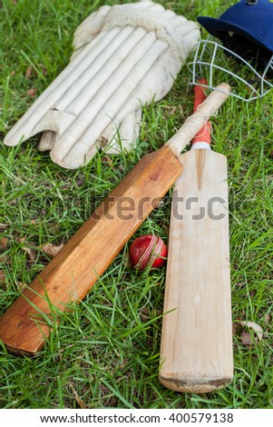 Cricket Equipment at cricket field,showcasing bats, balls, helmets and pads