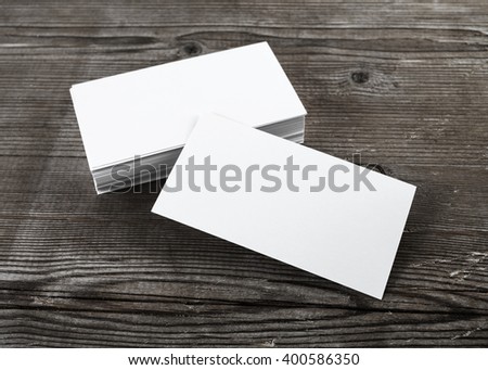 Photo of blank business cards with soft shadows on wooden background. For design presentations and portfolios. Template for ID.