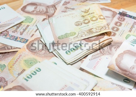 Stylish men's purse with money on wood background