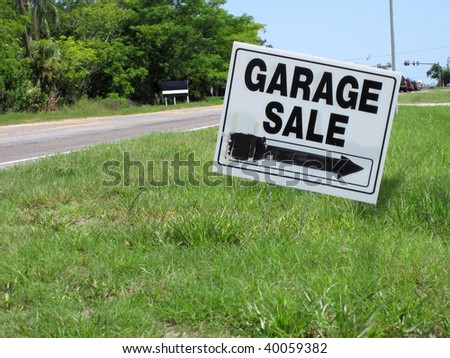an image of garage sale sign on green grass
