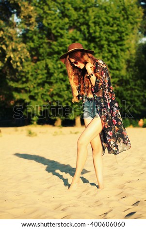 Fashion portrait of beautiful hippie young woman wearing boho chic clothes, summer, outdoors. Artsy bohemian style, hippie, gypsy style