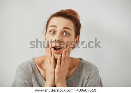 Surprise astonished woman. Closeup portrait woman looking surprised in full disbelief  wide open mouth isolated grey wall background. Positive human emotion facial expression body language. Funny girl