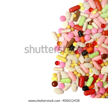 Lots of colorful tablets and pills, medical background. Macro. Isolated on white background.