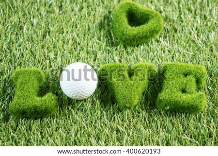 Love golf with golf ball and love word on green grass background for golfer's Valentine's day
