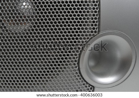 Close up of a metallic audio speaker grille. Technology, Music and Dance theme
