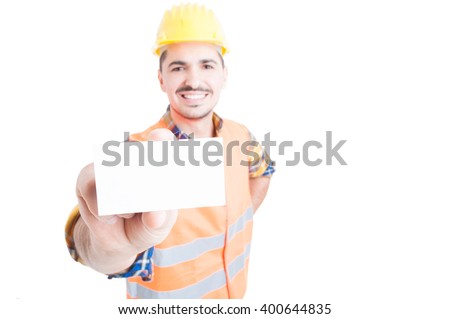 Cheerful constructor showing blank or empty visit card in close-up with advertising area isolated on white