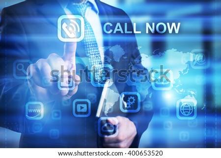 Businessman pressing call now icon on virtual screen .