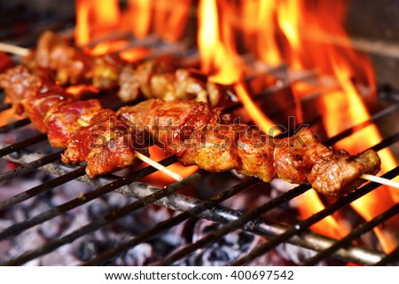 closeup of some meat skewers being grilled in a barbecue Royalty-Free Stock Photo #400697542