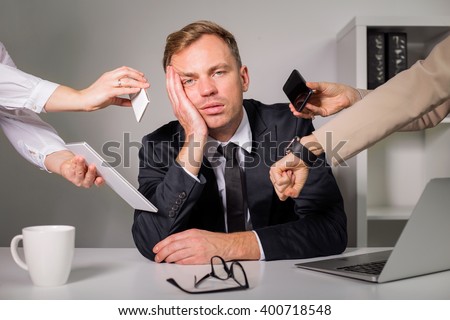 Tired man being overloaded at work  Royalty-Free Stock Photo #400718548