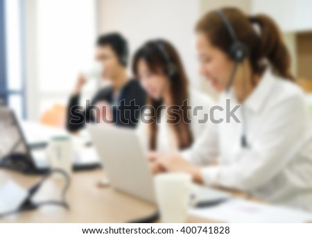 abstract blurred group of asian employee work as call center in office room Royalty-Free Stock Photo #400741828