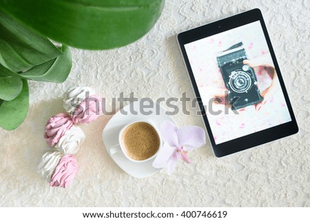 handmade marshmallows next Cup of coffee and a tablet with a picture of the camera