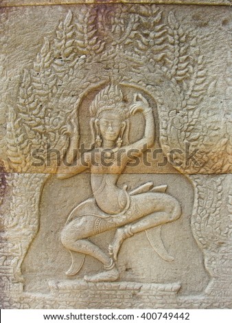 Dancing girls, apsaras or deities carved in the sandstone walls in Angkor Wat, Cambodia.