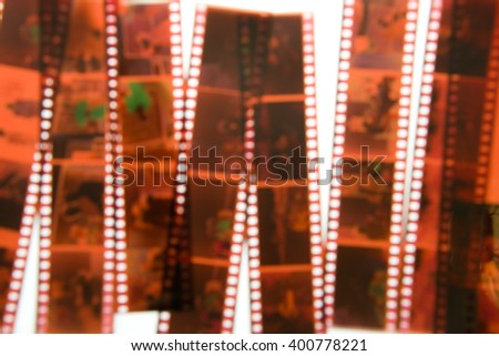 De-focused 35 mm color negative photo camera films vertical background on white