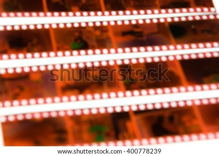 De-focused 35 mm color negative photo camera films horizontal background on white