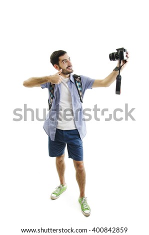 Travel concept. Full length studio portrait of handsome young man taking selfie. Isolated on white background


