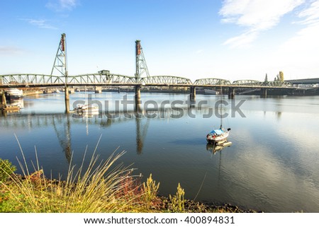 luxury yacht on tranquil water with steel bridge and skyline in portland