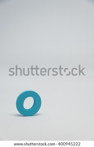 Blue Wooden alphabet O with white background in Vertical view