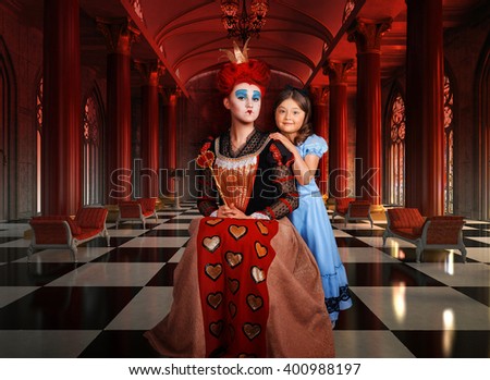 Portrait girl in costume Red Queen and little girl in a blue dress in the Hall of Columns