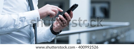 Close-up of elegant businessman picking up the number on his cell phone. Calling to important client