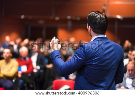 Speaker giving a talk on corporate Business Conference. Audience at the conference hall. Business and Entrepreneurship event. Royalty-Free Stock Photo #400996306