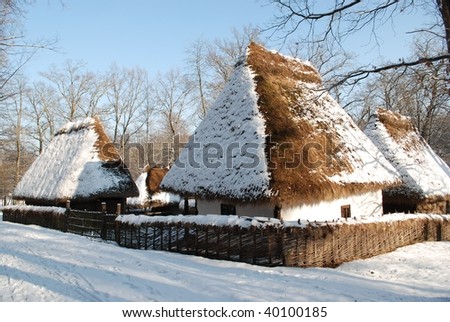 old wooden houses in snow